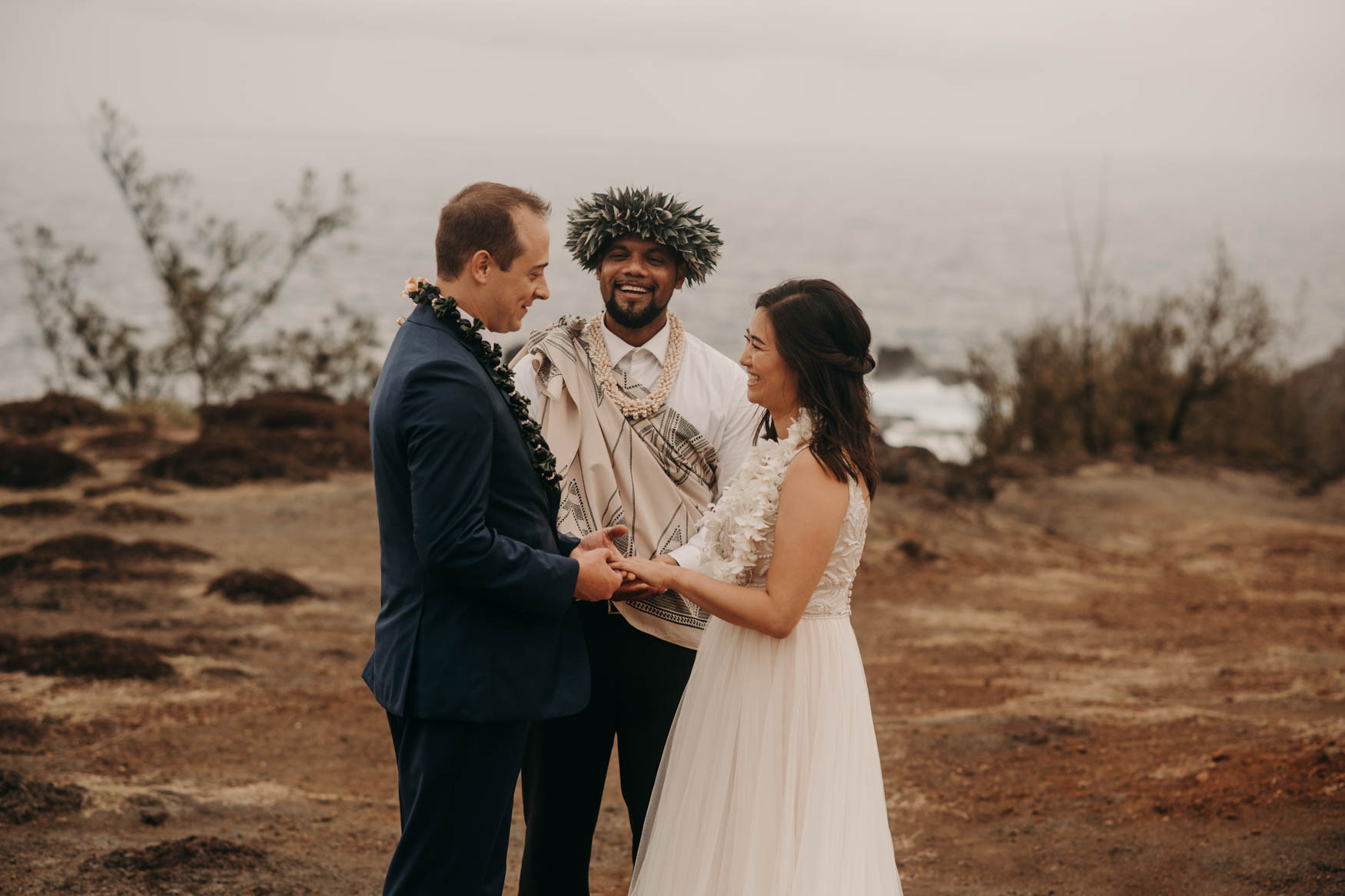 Andrew and Alison look at each other, beaming, while Euta stands next to them smiling as well.